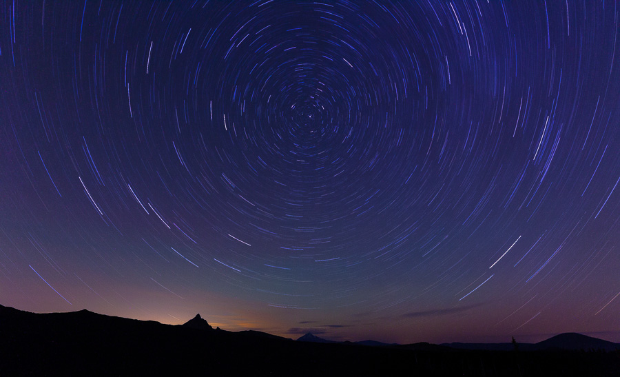 Star trails above the Deschutes National Forrest from Dee Wright Observatory. Mount Washington, Three Fingered Jack, and Black Butte are peaking on the horizon.